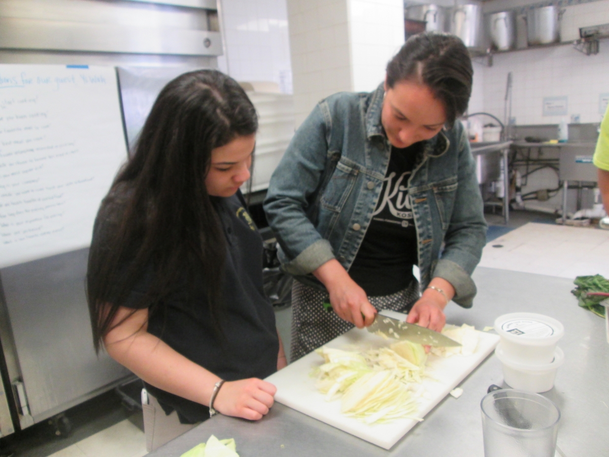 Caitlin demonstrating knife skills 