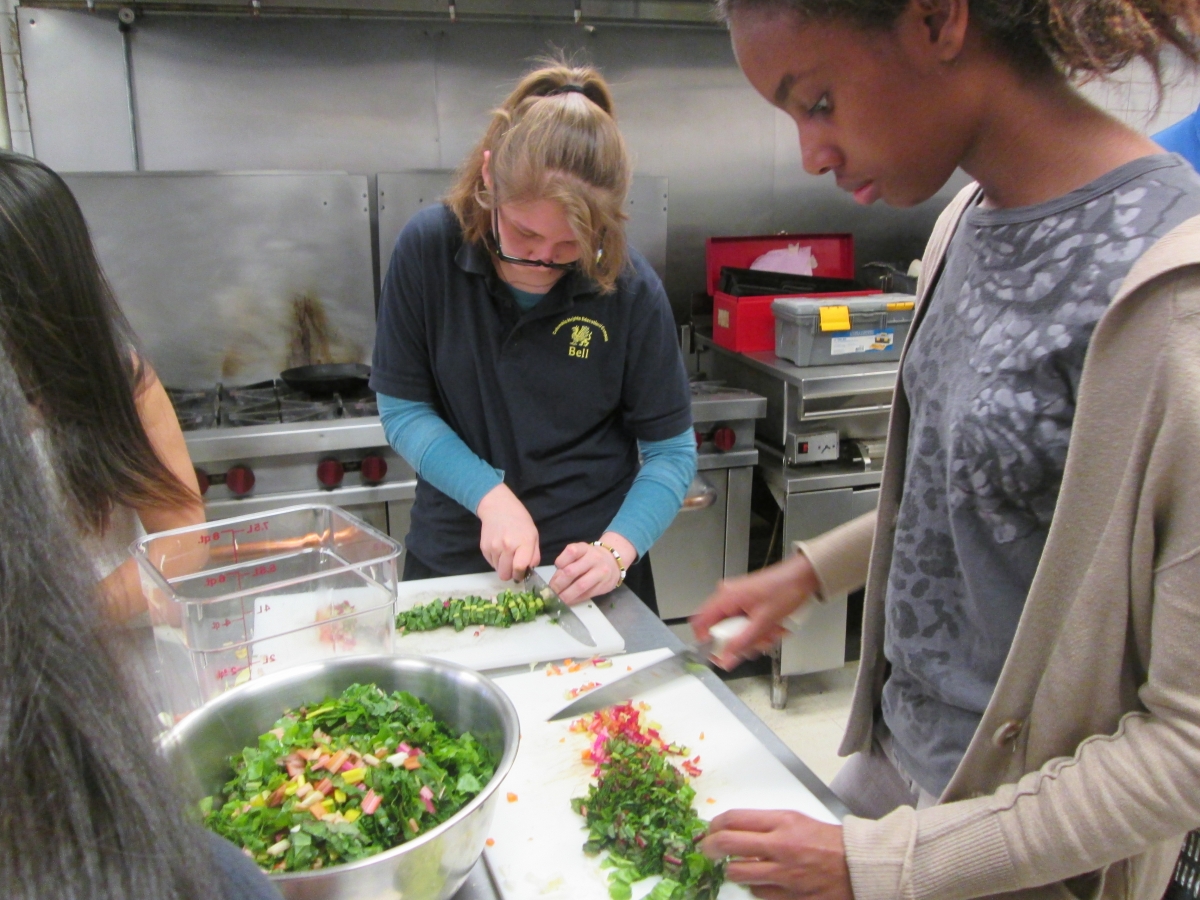 Teens chopping veggies